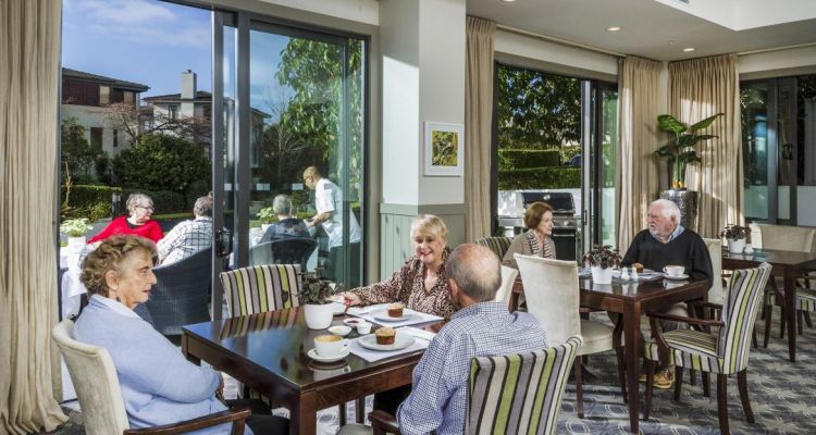 Residents enjoying tea & coffee at the cafe with outdoor terrace
